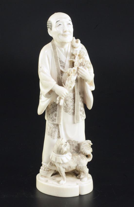 A Japanese ivory okimono of a farmer and a dog, early 20th century, 18.5cm